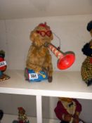 A vintage Japanese battery operated Monkey blowing a horn. Intermittently worked when tested.