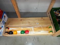 A child's croquet set in wooden box