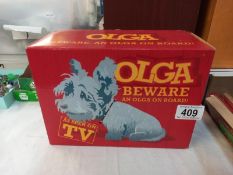 A boxed Paul O'Grady show, nodding Olga dog