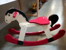 A painted wooden rocking horse (a/f ear missing)