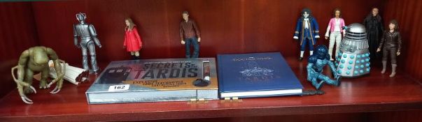 An assortment of Doctor Who figures plus Secrets of the Tardis & Tardis type 40 instruction manual