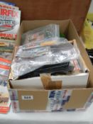 A box of model railway layout, trees, buildings and other accessories