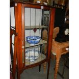 An Edwardian glazed bow front cabinet (one side glass missing). COLLECT ONLY.