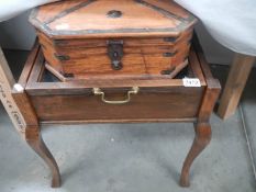 A piano stool converted to a display case and another box.