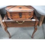 A piano stool converted to a display case and another box.