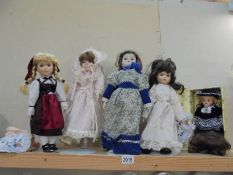Five porcelain collector's dolls.