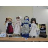 Five porcelain collector's dolls.