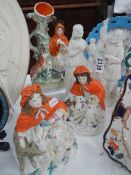 Four early 20th century Staffordshire and bisque figures.