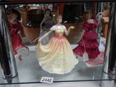 Four Royal Doulton figurines.