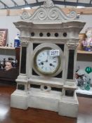 A Victorian French white marble style mantel clock.