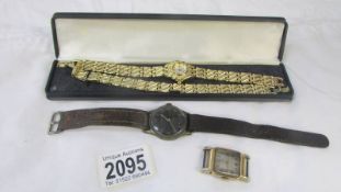 A wrist watch with matching bracelet, another wristwatch and a watch head.