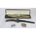 A wrist watch with matching bracelet, another wristwatch and a watch head.