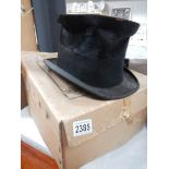A well worn top hat in box.