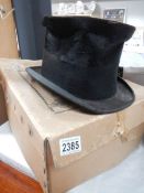 A well worn top hat in box.