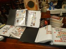 Four ring binders of assorted stamps.