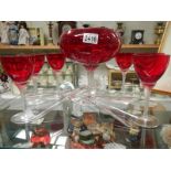 A large red glass bowl, set of 6 red glasses and two other glasses.