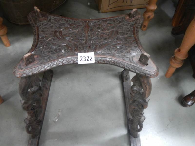 A carved stool, a/f.