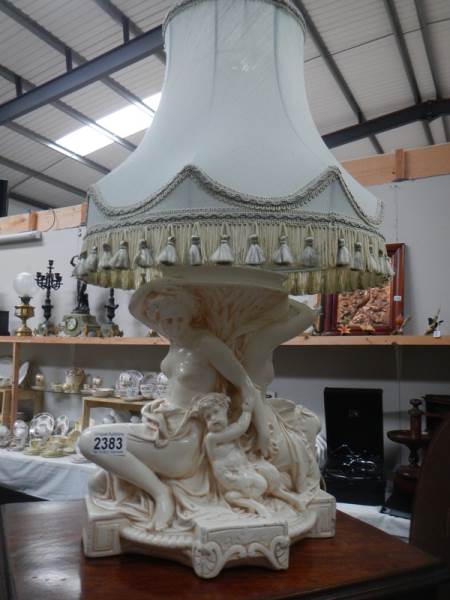 A figural table lamp with shade.