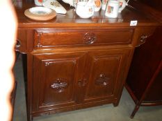 A Chinese style mahogany cabinet. COLLECT ONLY.
