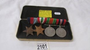 A set of WW2 medals mounted on a bar.