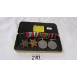 A set of WW2 medals mounted on a bar.