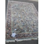 A green patterned rug depicting animals.