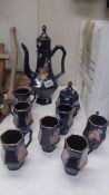 A hand painted blue ceramic coffee set.