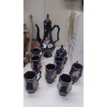 A hand painted blue ceramic coffee set.