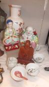 Three Buddha figures, a large Chinese vase, rice bowls and spoons.