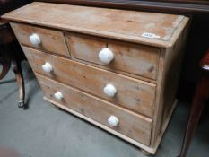 An old stripped pine 2 over 2 chest of drawers with ceramic knobs, COLLECT ONLY.