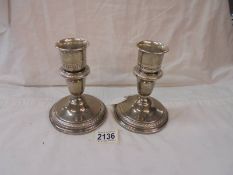 A pair of silver candlesticks.
