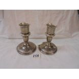 A pair of silver candlesticks.