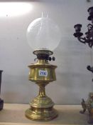 A brass oil lamp with later etched glass shade. COLLECT ONLY.