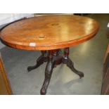An oval inlaid tip top table. COLLECT ONLY.