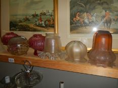 A quantity of old glass lampshades.
