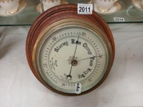A cased ship's barometer.