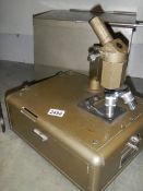 An old microscope by Flatters & Garnett Ltd.,