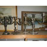 Four silver plate candelabra.