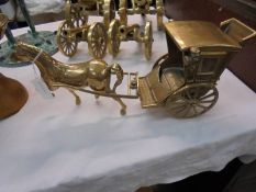A solid brass model of a hansom cab with horse.