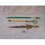 A sword letter opener and two toasting forks.