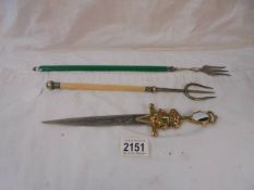 A sword letter opener and two toasting forks.