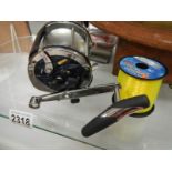A Riptide fishing reel with roll of line.