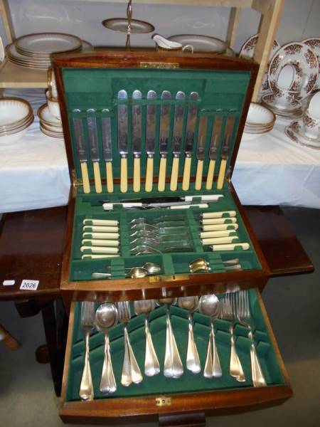 A canteen of cutlery with drawer in bottom.