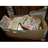 A box of stamps and stamp albums.