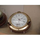 A cased brass quartz ship's clock.