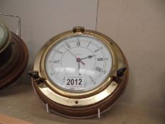A cased brass quartz ship's clock.