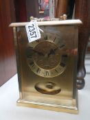 A brass mantel clock in working order.