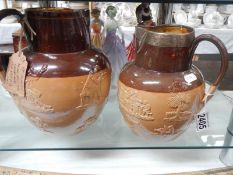 Two Doulton Lambeth jugs, one with silver collar.