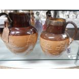 Two Doulton Lambeth jugs, one with silver collar.