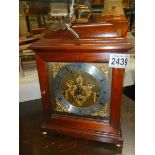 A mahogany mantel clock.